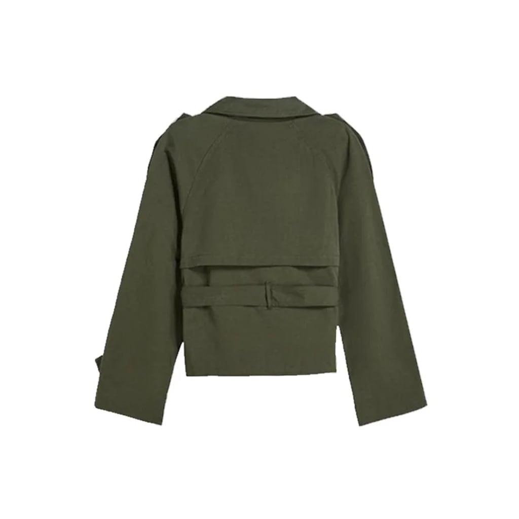 Back view of cropped trench coat on model, showcasing structured silhouette and epaulet detail